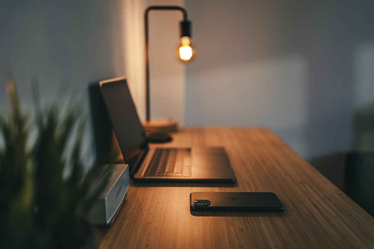 Walnut desk setup with laptop and coffee
